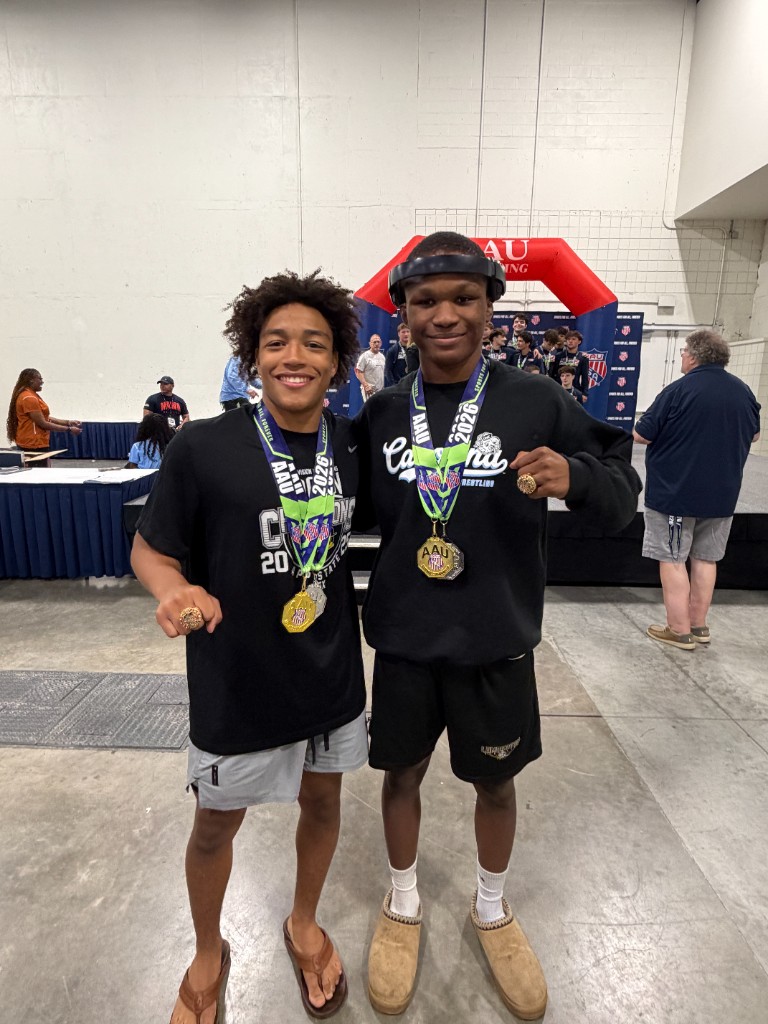 Mac Johnson and Aaron Ellison with AAU championship medals and rings