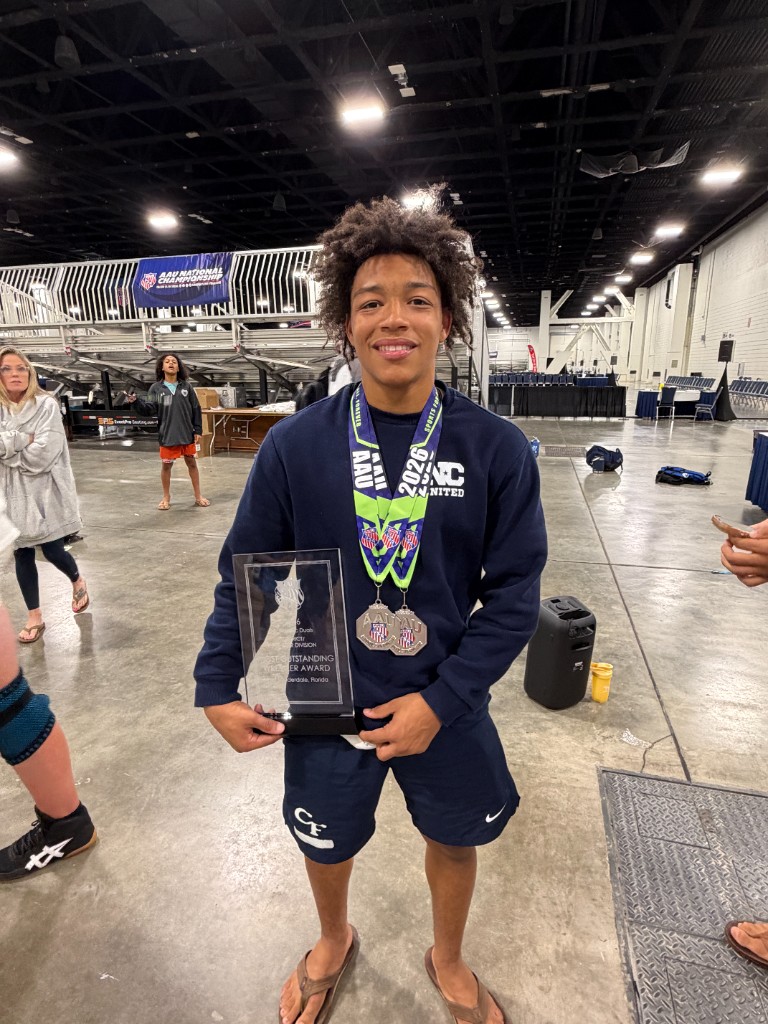 Mac Johnson with AAU Scholastic Duals Most Outstanding Wrestler plaque and medals