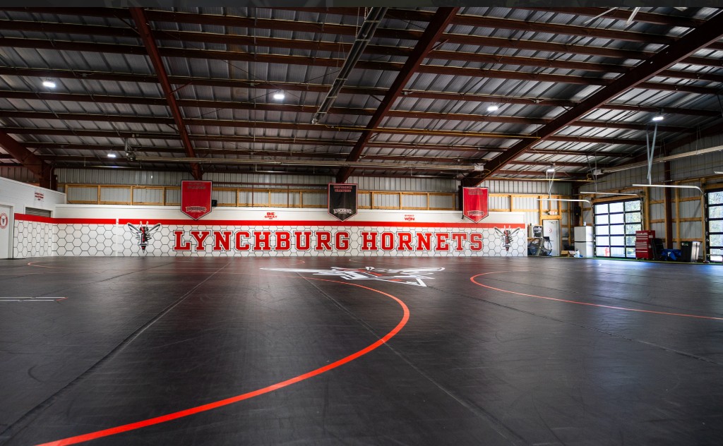 Lynchburg Hornets wrestling facility: competition mats, Lynchburg Hornets wall branding, and training space